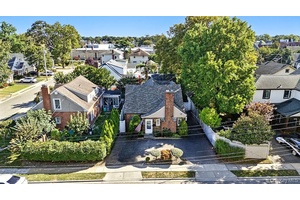 Welcome home to this charming and spacious 4 bedroom, 2 bath expanded Cape in the Village of Rockville Centre.