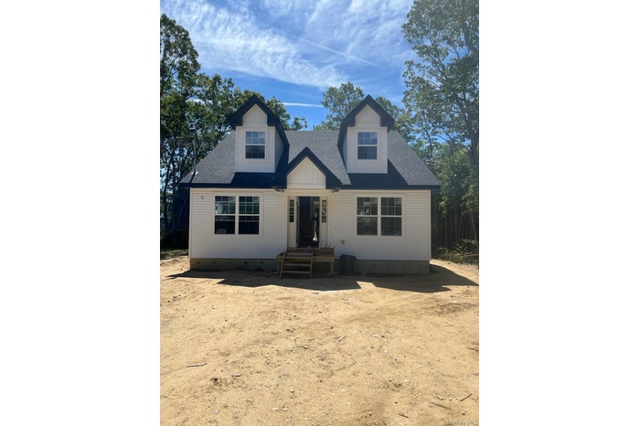 View of front of property with a shingled roof