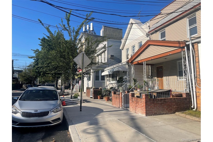 View of asphalt street featuring sidewalks and curbs