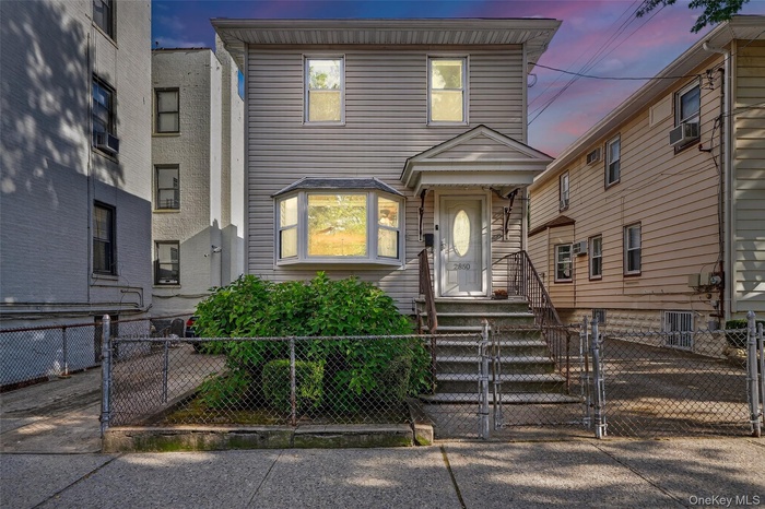 View of front of home featuring a gate and a fenced front yard
