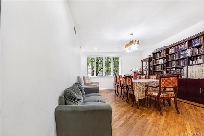 Dining space with a chandelier and light hardwood / wood-style floors