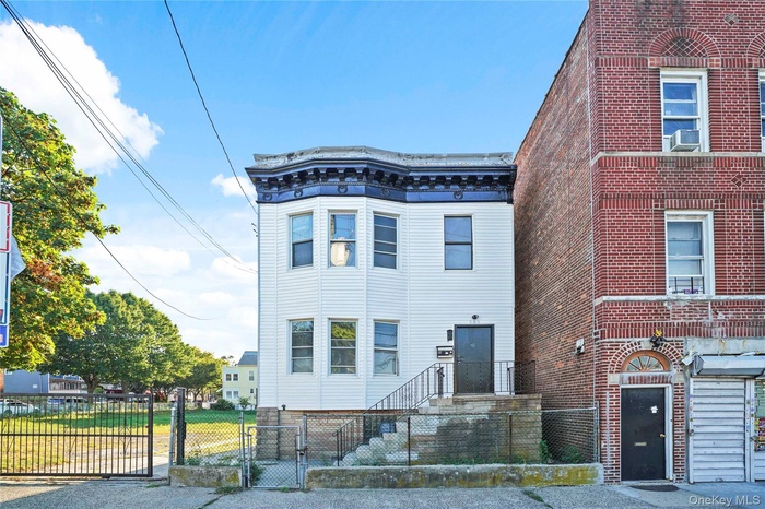 View of front of property with a gate and a fenced front yard