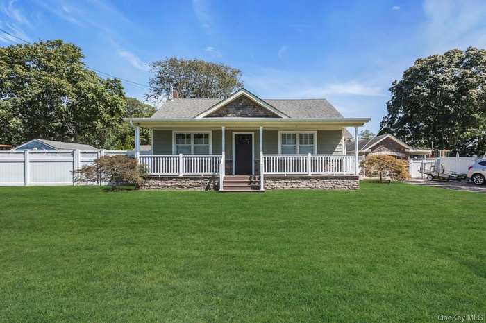 Bungalow featuring covered porch, a chimney, and roof with shingles