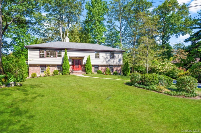 Welcome home to 150 Maywood Road in beautiful Larchmont Woods.