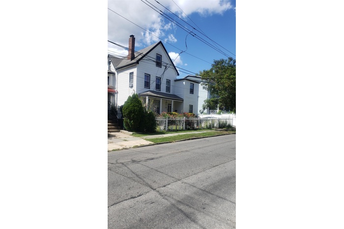 View of front of home with a porch and a chimney