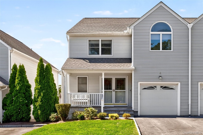 Townhouse lifestyle with a single home feel. Covered porch, driveway, and a garage.