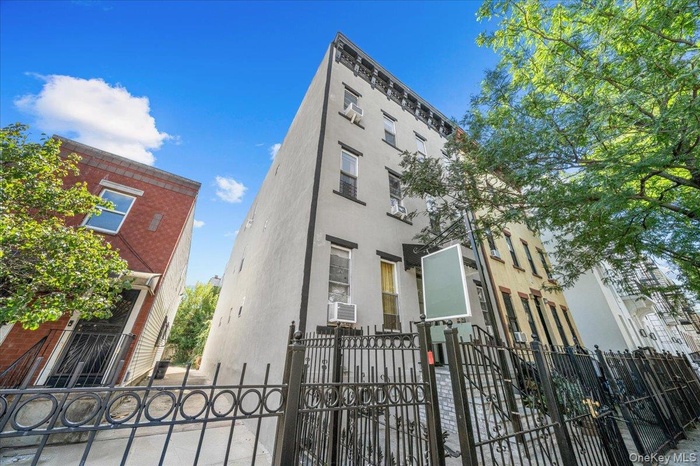 View of building exterior with a fenced front yard
