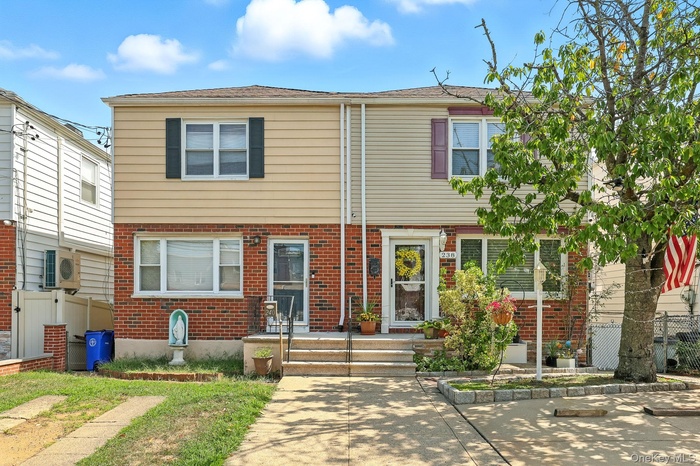 Colonial-style house with brick siding
