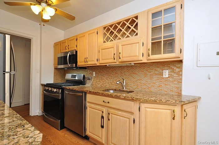 Updated Eat-in-Kitchen has granite counters and stainless steel appliances including a dishwasher, range, microwave and refrigerator.