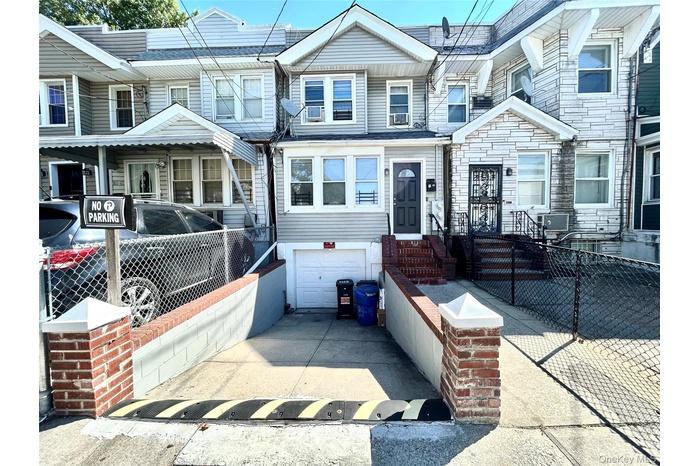 View of front of home featuring concrete driveway and a garage