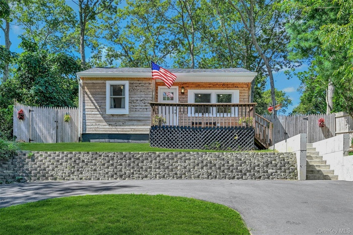 View of front of home featuring a wooden deck and stairs