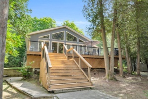 Discover this charming year round waterfront home on Clear Lake, offering 3 bedrooms, 2 bathrooms, 180 feet of west facing shoreline for breathtaking sunsets, and 1.