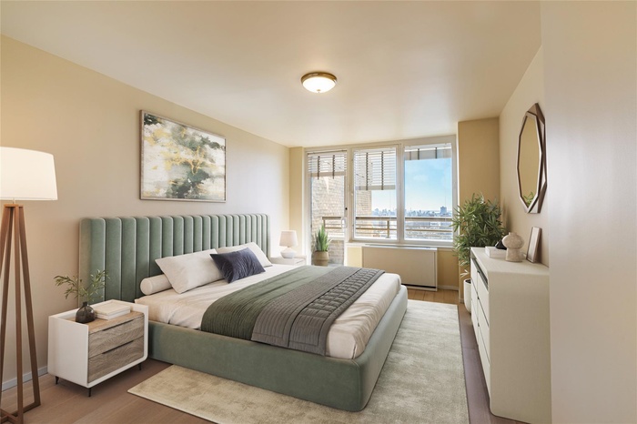 Bedroom featuring baseboards, wood finished floors, and radiator heating unit