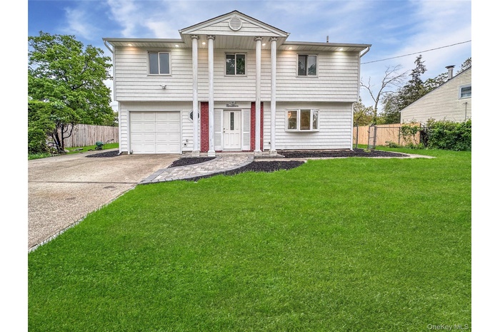 View of front of house featuring driveway and a garage