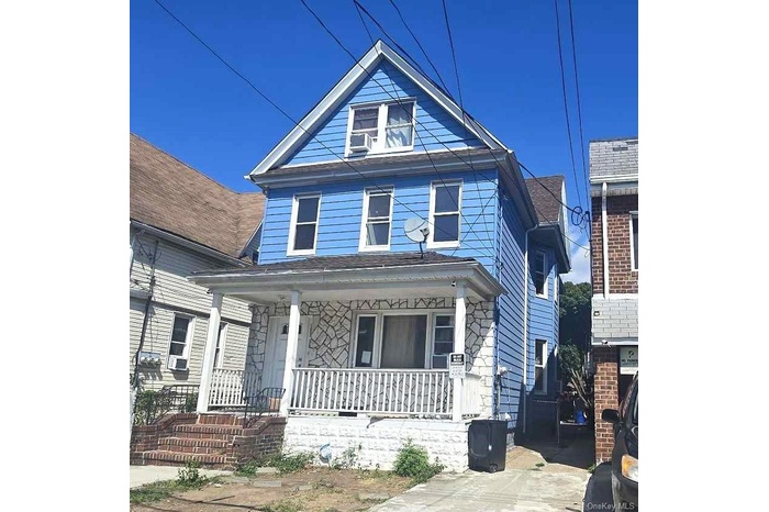 American foursquare style home featuring covered porch