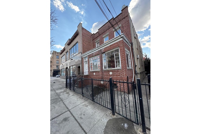 View of building exterior with a fenced front yard