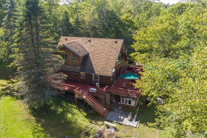 View of subject property with a forest