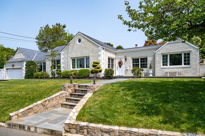 Ranch-style home featuring a front yard