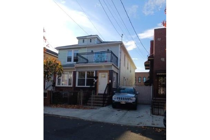 American foursquare style home with a balcony