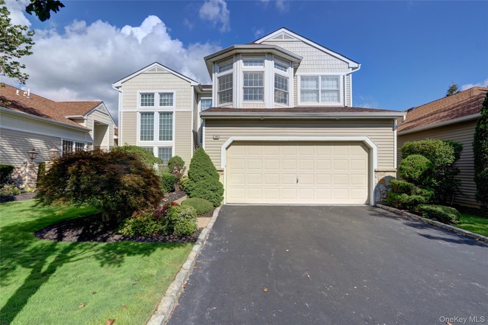 Traditional-style home featuring driveway and an attached garage