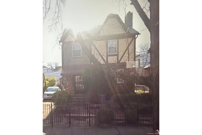 View of front of home featuring a fenced front yard and a chimney