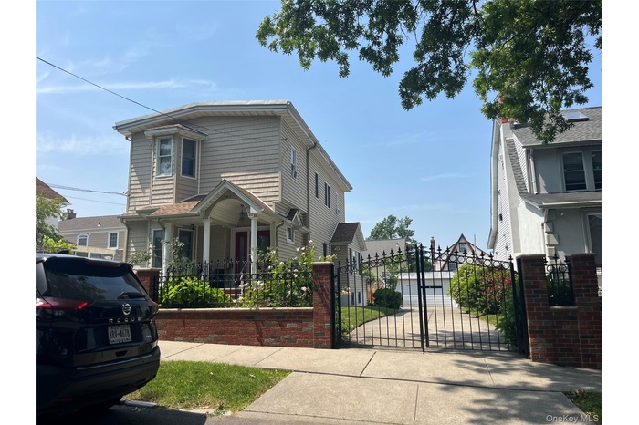 View of front of property featuring a gate