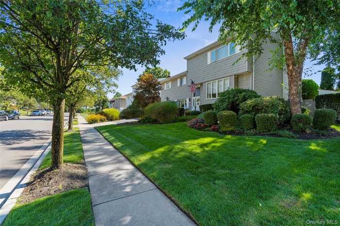 View of green lawn with a residential view