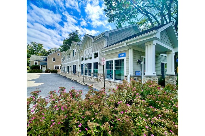 View of front/side of commercial and residential properties with covered porch