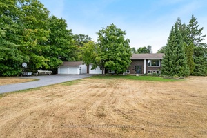 Country living, in town. On big treed acre, immaculate brick home offers wonderful family spaces both inside and out.