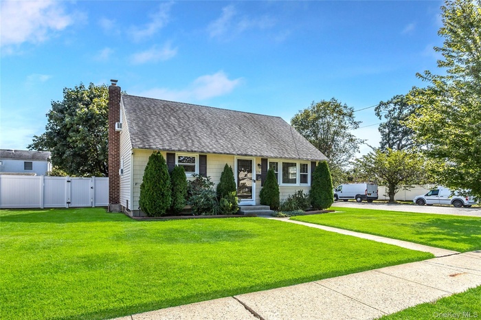 View of front of home featuring roof with shingles, a gate, and a chimney
