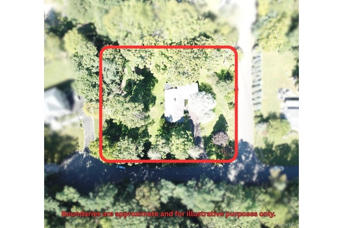 Aerial view of property and surrounding area featuring property boundaries highlighted