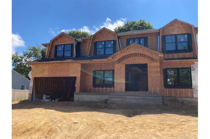 Property under construction with a gambrel roof and a patio