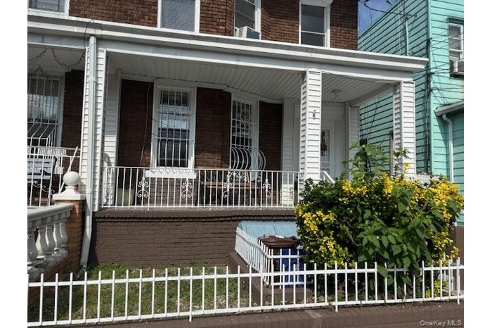 Property entrance with brick siding and a porch