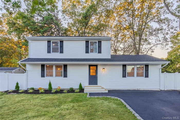 Traditional home featuring a shingled roof