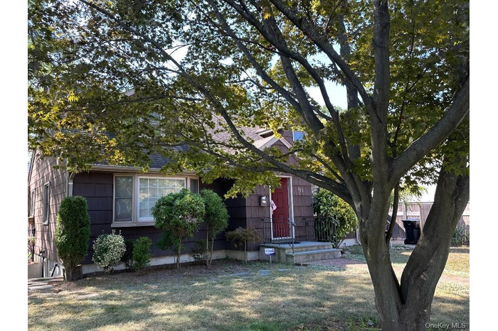 Front of house with beautiful tree