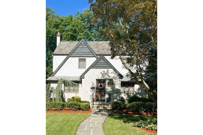 Tudor house with a front yard