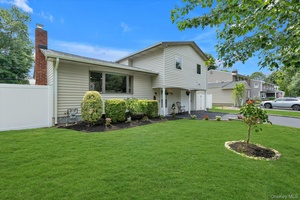 Melville, Stunning Country Village Split located in the heart of the neighborhood, on a tree lined street and within the Half Hollow Hills School District.