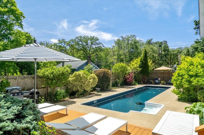 Heated, saltwater pool with deck and perennial gardens