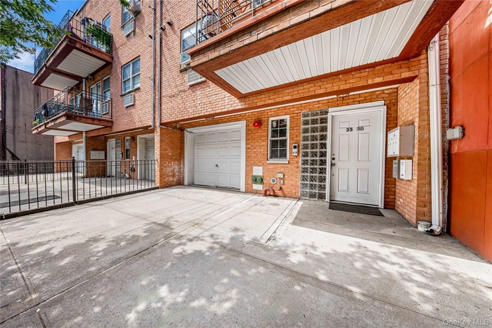 Garage featuring concrete driveway