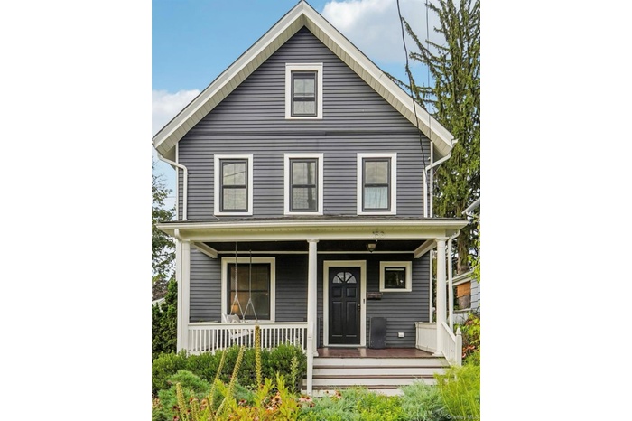 Traditional style home featuring covered porch