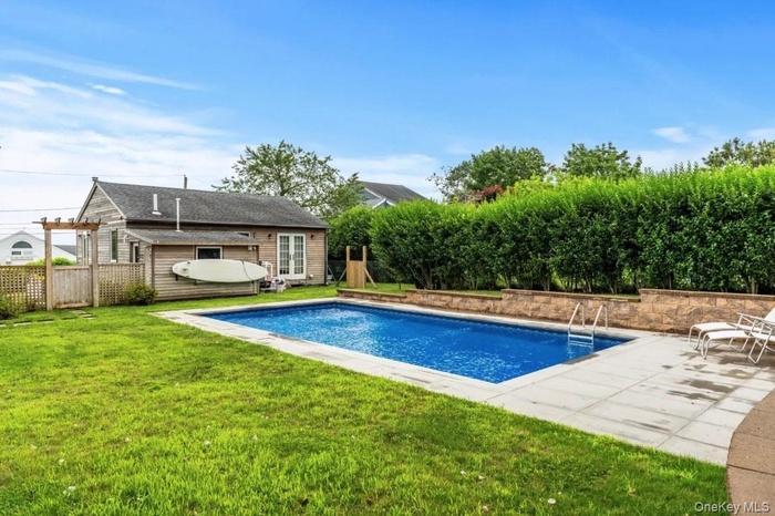 View of pool featuring french doors and a patio