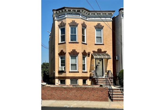 Italianate home with brick siding and cooling unit