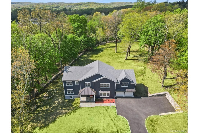 Drone / aerial view featuring a wooded view
