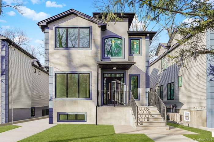 View of front of house featuring stucco siding and a front yard