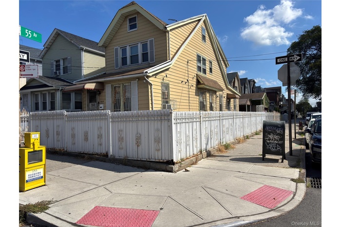View of front of home with a fenced front yard and a residential view