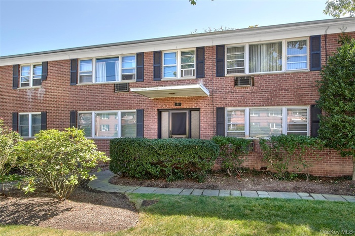 View of front of home featuring brick siding