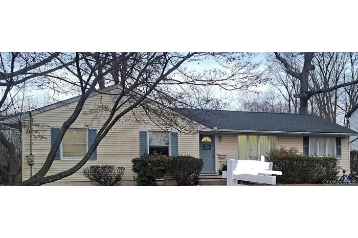 View of front of house featuring roof with shingles
