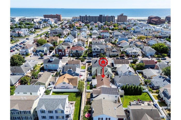 Aerial perspective of suburban area featuring a large body of water