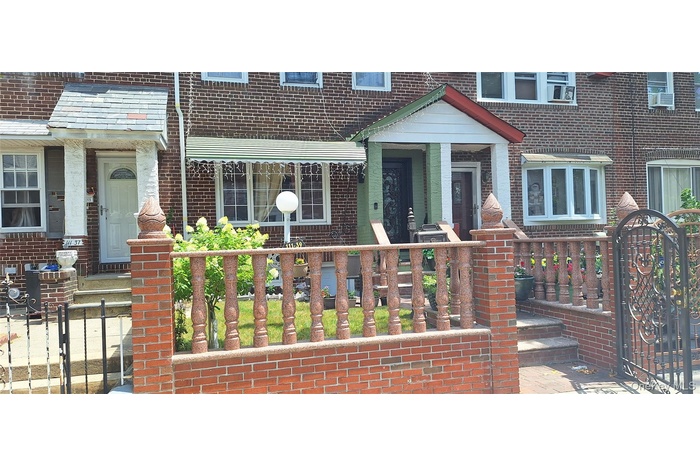 View of exterior entry featuring brick siding