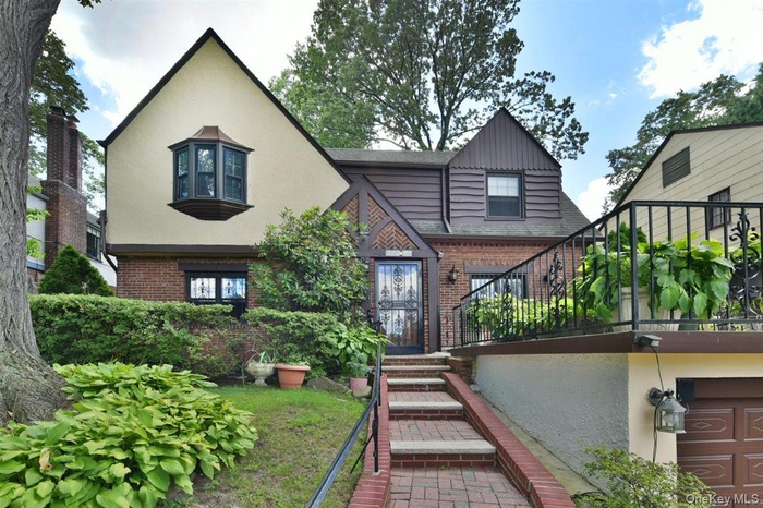 Back of property with brick siding and stucco siding